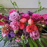bright pink and purple flowers in glass vase