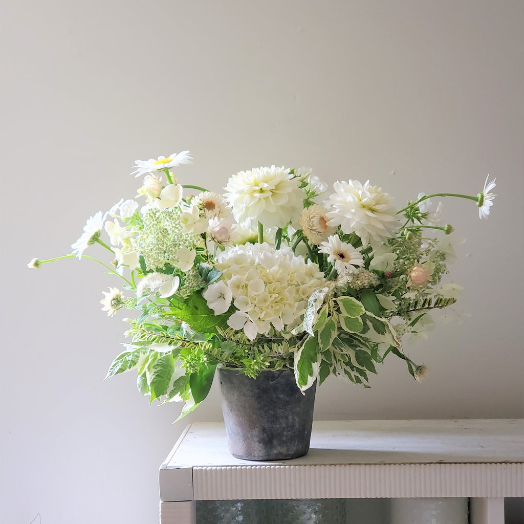 seasonal white flowers with greenery in vase